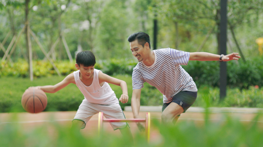 Father and son playing basketball