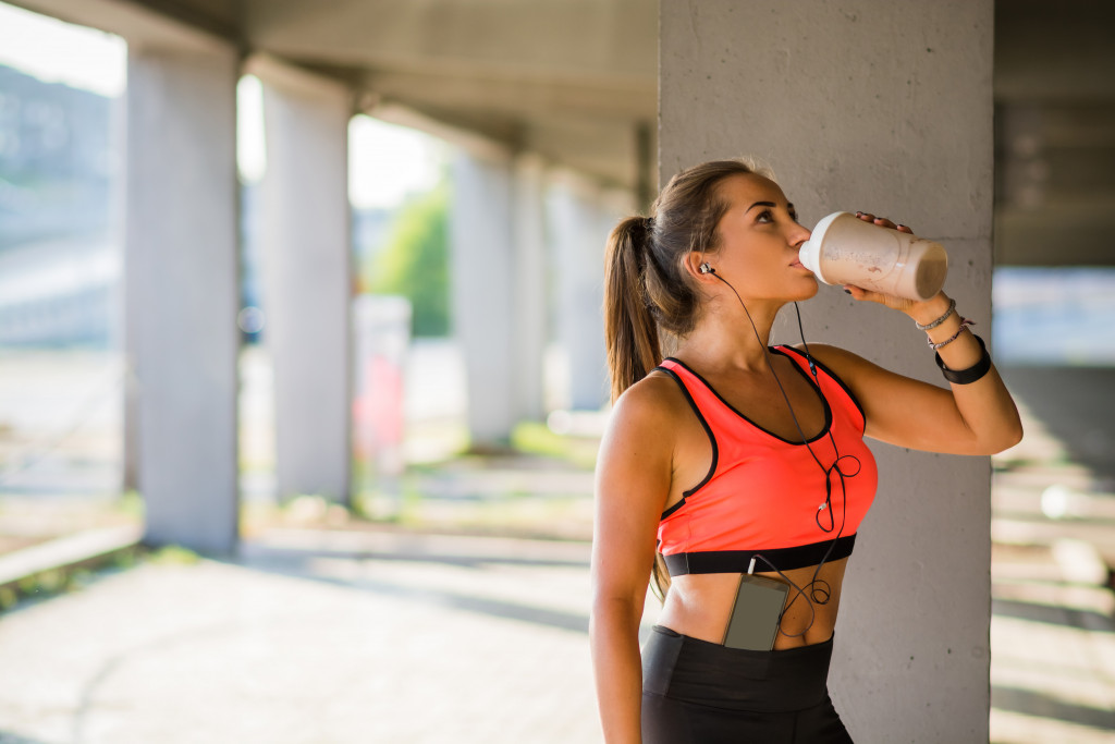 A woman drinking water from a bottle