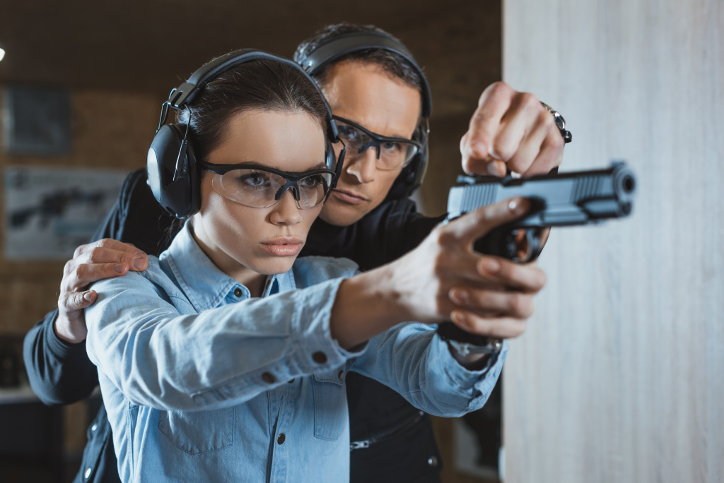 A woman being taught gun safety