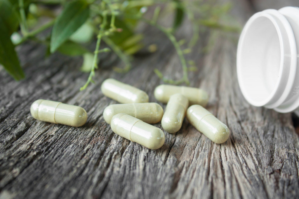 a bunch of green capsule supplements