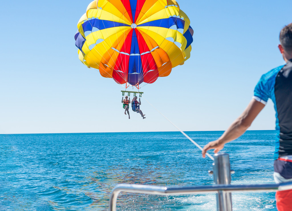 Couple under parachute hanging mid air