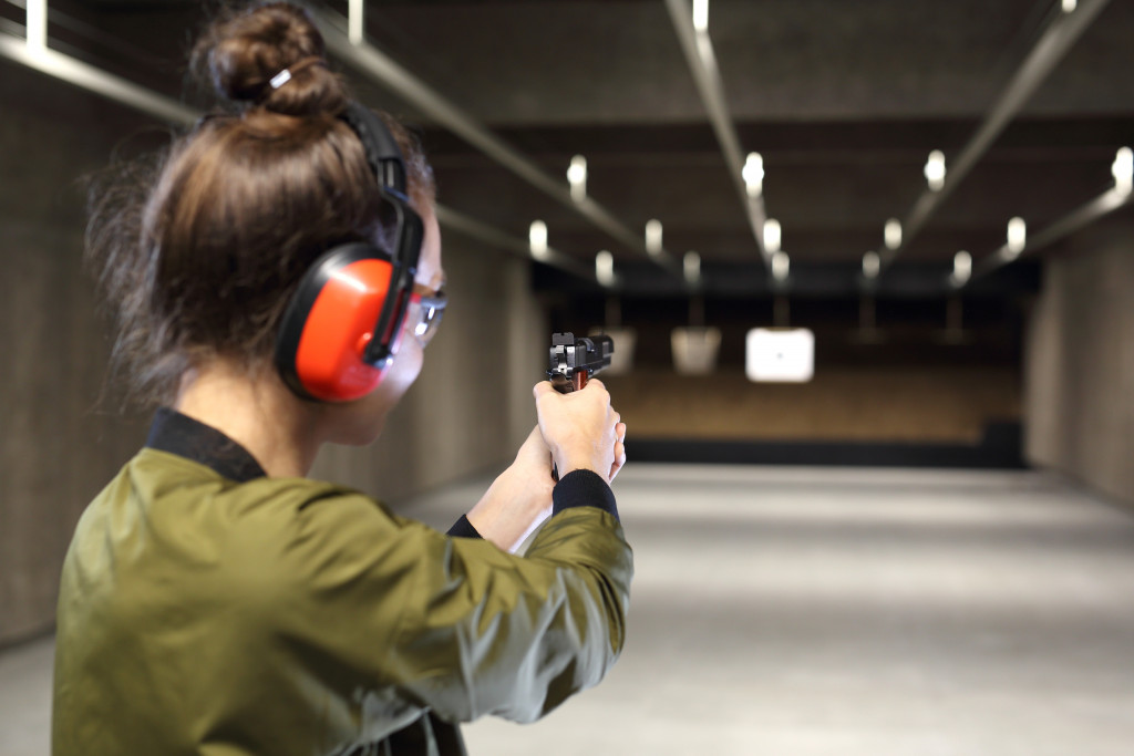 woman engaging in gun range shooting