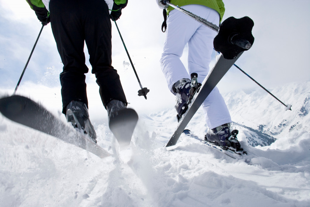 close shot of two skiing people down a snow slope