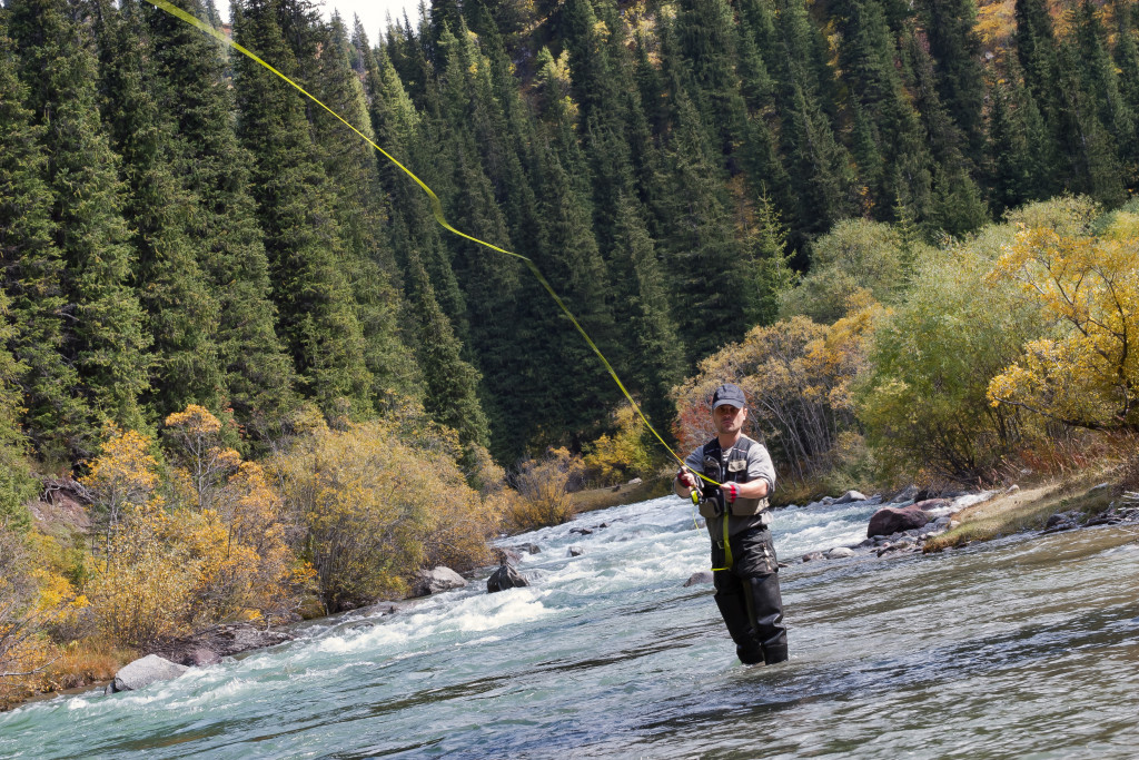 A man fly fishing on a river