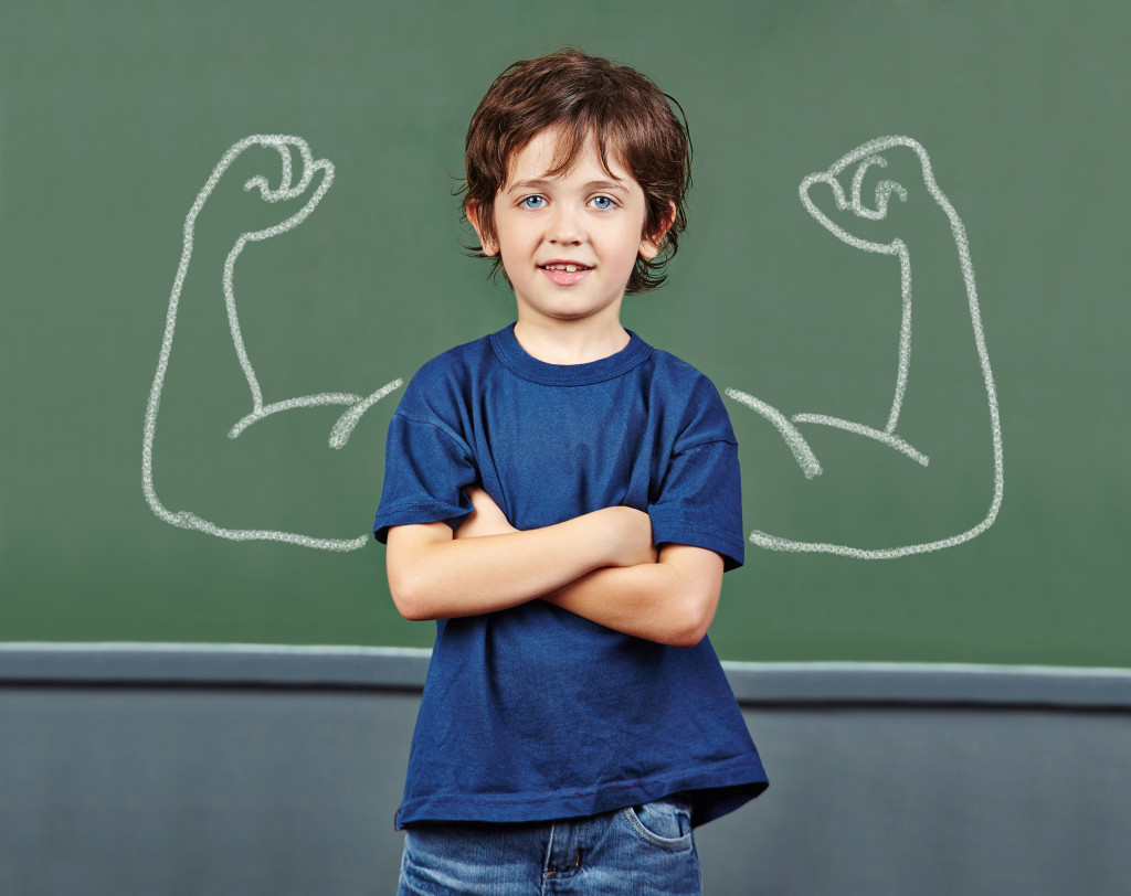 Strong child with muscle drawings