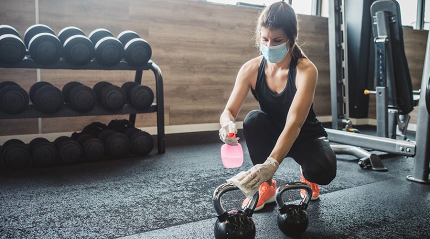 sportswoman disinfecting after sports training in health club.