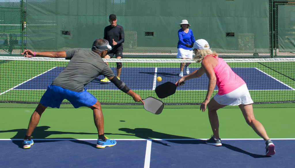 a group of people playing pickleball