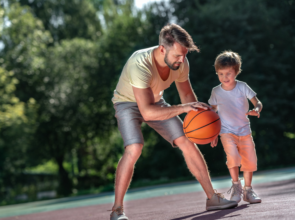 father and son doing basketball