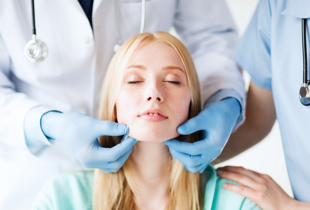 a woman getting medical treatment from a doctor